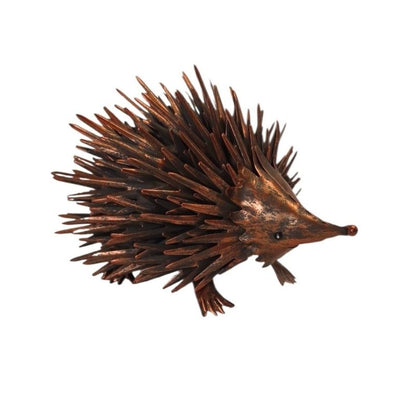 A small hedgehog figurine with dark brown and reddish-brown spines, a brown body, and a long snout, shown on a plain white background.