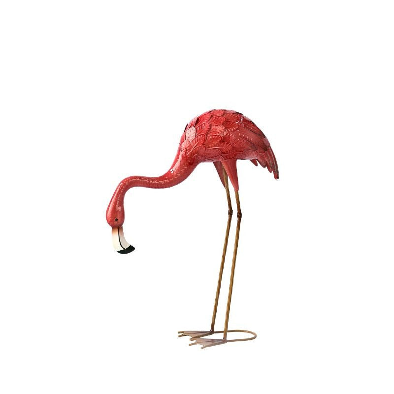 Pink flamingo statue on a white background